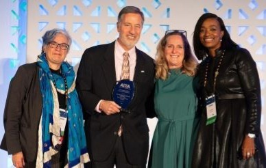 UC San Diego and AIEA leadership pose with award during ceremony