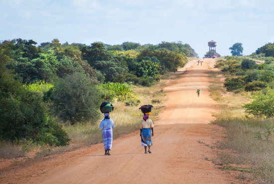 Two Villagers from Mozambique Walking Down a Dirt Road