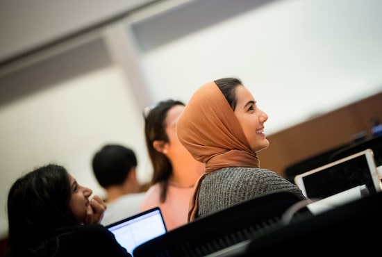 Student smiling in a classroom